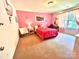 Bright bedroom with a playful design, featuring pink walls, a large window, and cozy furnishings at 1528 Magnolia Dr # 8, Lancaster, SC 29720