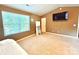 Bright bedroom with a large window, beige carpet, and a mounted TV at 1528 Magnolia Dr # 8, Lancaster, SC 29720