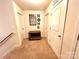 Bright hallway featuring a decorative mirror, neutral walls, and multiple entryways at 1528 Magnolia Dr # 8, Lancaster, SC 29720