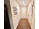 Hallway with neutral walls, hardwood flooring, and multiple white doors at 1528 Magnolia Dr # 8, Lancaster, SC 29720