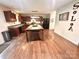 Open kitchen featuring dark cabinetry, a black refrigerator, and a large wooden kitchen island at 1528 Magnolia Dr # 8, Lancaster, SC 29720