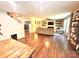 Open-concept living room with hardwood floors, a ceiling fan, and a decorative fireplace with built-in shelving at 1528 Magnolia Dr # 8, Lancaster, SC 29720