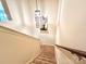 Carpeted stairs leading to the upper level with a decorative mirror and lighting at 1528 Magnolia Dr # 8, Lancaster, SC 29720