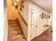 Carpeted stairway with a wooden handrail leading to the upper level of the home at 1528 Magnolia Dr # 8, Lancaster, SC 29720