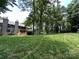 Expansive backyard with lush green lawn, mature trees, and a view of the multi-level deck at 1590 Springpoint Rd # B, Rock Hill, SC 29732