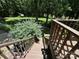 Wooden stairs lead down to a lush green yard with mature trees and views of the lake at 1590 Springpoint Rd # B, Rock Hill, SC 29732