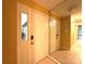 Bright foyer with neutral tile flooring, yellow walls, mirrored wall, and a white front door with a glass panel at 1590 Springpoint Rd # B, Rock Hill, SC 29732