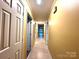 Inviting hallway with neutral walls, tile flooring, and well-lit with access to multiple rooms at 1590 Springpoint Rd # B, Rock Hill, SC 29732