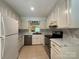 Updated kitchen featuring white cabinets, marbled countertops, and stainless steel appliances for a modern look at 1590 Springpoint Rd # B, Rock Hill, SC 29732