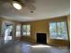 Bright living room with tile floors, fireplace, ceiling fan, and windows offering views of a screened porch and lake at 1590 Springpoint Rd # B, Rock Hill, SC 29732