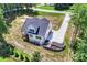 Aerial view of a modern home featuring a driveway and landscaped backyard at 164 Meadow Glen Dr, Troutman, NC 28166