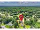 Aerial view of the property showing its location in a wooded neighborhood with surrounding greenery at 164 Meadow Glen Dr, Troutman, NC 28166