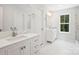 Bathroom featuring double vanities, marble floors, and a glass shower at 164 Meadow Glen Dr, Troutman, NC 28166