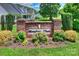 Meadow Glen community entrance sign featuring brick pillars and colorful landscaping at 164 Meadow Glen Dr, Troutman, NC 28166