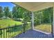 Scenic deck overlooking a lush green backyard and mature trees at 164 Meadow Glen Dr, Troutman, NC 28166