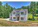 Attractive two-story home displaying a well-manicured lawn, mature trees, and a welcoming facade in a peaceful setting at 164 Meadow Glen Dr, Troutman, NC 28166