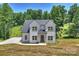Charming two-story home showcasing classic design, a lush lawn, and a paved driveway, inviting comfort and style at 164 Meadow Glen Dr, Troutman, NC 28166