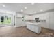 Bright, open kitchen with white cabinets, a large island with a sink, and stainless steel appliances at 164 Meadow Glen Dr, Troutman, NC 28166