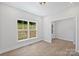 A bright living room features wood floors and a large window, offering natural light and a view of the outdoors at 164 Meadow Glen Dr, Troutman, NC 28166
