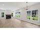 Spacious living room with fireplace and large windows with backyard views at 164 Meadow Glen Dr, Troutman, NC 28166