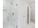 Shower featuring marble-tiled walls and glass door at 164 Meadow Glen Dr, Troutman, NC 28166