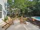Backyard patio space with wooden chairs, providing a serene setting next to the pool at 16411 Greybriar Forest Ln, Charlotte, NC 28278