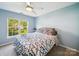 Inviting bedroom with a cozy bed, natural light, and calming blue walls at 16411 Greybriar Forest Ln, Charlotte, NC 28278