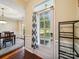Welcoming entryway features a bright dining room, decorative door, and a convenient black shelf near the front door at 16411 Greybriar Forest Ln, Charlotte, NC 28278