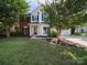 Charming two-story home with landscaped yard, green shutters, and a mix of brick and vinyl siding at 16411 Greybriar Forest Ln, Charlotte, NC 28278