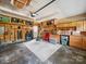 Spacious garage with ample storage, pegboard walls, and overhead lighting at 16411 Greybriar Forest Ln, Charlotte, NC 28278