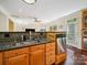 Kitchen space with stainless steel dishwasher and sink, dark granite countertop, and wooden drawers for ample storage at 16411 Greybriar Forest Ln, Charlotte, NC 28278