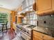 Modern kitchen with stainless steel appliances, granite counters, wooden cabinets, and view of outdoor eating area at 16411 Greybriar Forest Ln, Charlotte, NC 28278