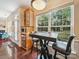 Inviting breakfast nook featuring a large window, wooden cabinets, and seating area, perfect for casual dining at 16411 Greybriar Forest Ln, Charlotte, NC 28278