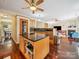 Open-concept kitchen with dark countertops, wooden cabinetry, and connection to the living room, creating a welcoming atmosphere at 16411 Greybriar Forest Ln, Charlotte, NC 28278