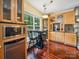 Cozy breakfast nook adjacent to the kitchen with wooden cabinets, stainless steel appliances, and lots of natural light at 16411 Greybriar Forest Ln, Charlotte, NC 28278