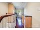 Inviting landing area with hardwood floors featuring a built-in desk, cabinets, and natural light at 16411 Greybriar Forest Ln, Charlotte, NC 28278