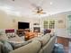 Living room featuring fireplace, television, hardwood floors, and a large sectional for comfortable living at 16411 Greybriar Forest Ln, Charlotte, NC 28278