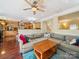 Open living space with view of modern kitchen and staircase, featuring cozy couch and hardwood floors at 16411 Greybriar Forest Ln, Charlotte, NC 28278
