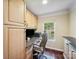 Small office featuring a custom desk, natural light, and wooden floors at 16411 Greybriar Forest Ln, Charlotte, NC 28278