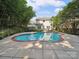 In-ground pool with lush landscaping, a concrete patio, and a view of the two-story home at 16411 Greybriar Forest Ln, Charlotte, NC 28278