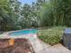 Inviting backyard featuring a sparkling in-ground pool and lush landscaping at 16411 Greybriar Forest Ln, Charlotte, NC 28278