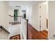 Bright upstairs hallway features hardwood floors, white doors, and access to multiple rooms for convenience at 16411 Greybriar Forest Ln, Charlotte, NC 28278