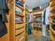 Organized walk-in closet with built-in shelving, drawers, and ample storage space at 16411 Greybriar Forest Ln, Charlotte, NC 28278