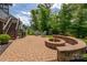 Charming backyard featuring a stone patio with firepit, grill, and stair access at 1805 Trading Path Ln, Waxhaw, NC 28173