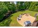 Beautiful backyard with a stone patio, fire pit, and lush green lawn at 1805 Trading Path Ln, Waxhaw, NC 28173