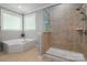 This bathroom features a soaking tub, a separate shower, and bright, natural light at 1805 Trading Path Ln, Waxhaw, NC 28173