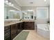 This primary bathroom features a double vanity, soaking tub, and elegant finishes at 1805 Trading Path Ln, Waxhaw, NC 28173
