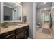 Well-lit bathroom with a granite countertop, dark wood cabinets, and a hallway view at 1805 Trading Path Ln, Waxhaw, NC 28173