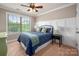 Inviting bedroom featuring a large window, ceiling fan, and charming interior design at 1805 Trading Path Ln, Waxhaw, NC 28173