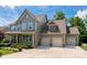 Charming two-story home with a three-car garage, landscaped yard, and inviting front porch at 1805 Trading Path Ln, Waxhaw, NC 28173